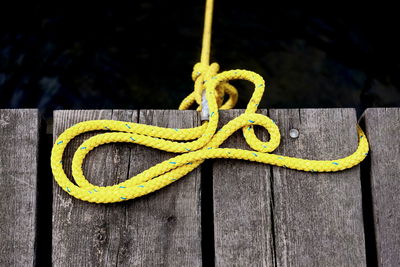 Close-up of rope tied on wood
