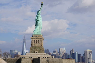 Statue of liberty against buildings in city