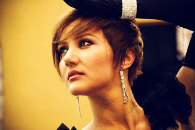 Close-up of thoughtful model wearing diamond jewelry