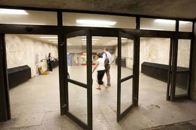 People walking in corridor of building