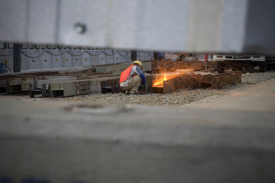 Worker welding metal at construction site