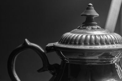 Close-up of drink on table against black background