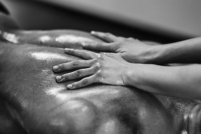 Woman massaging man lying on bed