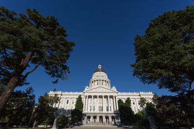 Low angle view of historical building against blue sky