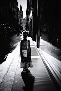 Rear view of woman walking on street in city