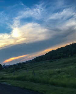 Scenic view of field against sky during sunset