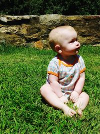 Boy sitting on grass