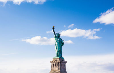 Low angle view of statue against cloudy sky