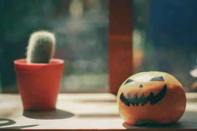 Close-up of cup with ball on table