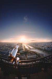 Aerial view of cityscape against sky during sunset