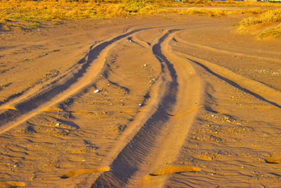 High angle view of tire tracks on road