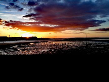 Scenic view of dramatic sky over sea during sunset