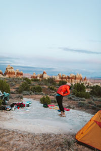 Female camper back bending before bedtime in the utah desert