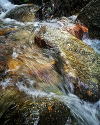 View of river flowing through rocks