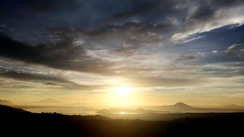 Scenic view of silhouette mountains against sky at sunset