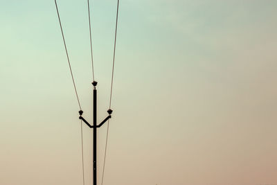 Power line with minimalist sky background.