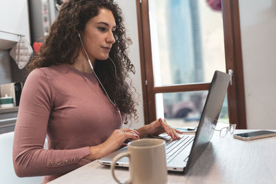 Young woman is working from home on the computer during restrictions due to the covid-19 pandemic