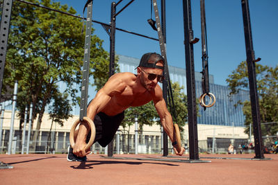 Low angle view of man exercising on street