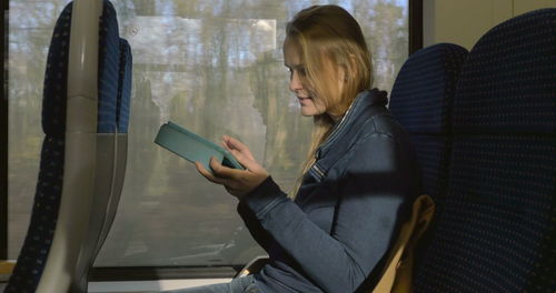 Side view of woman using mobile phone