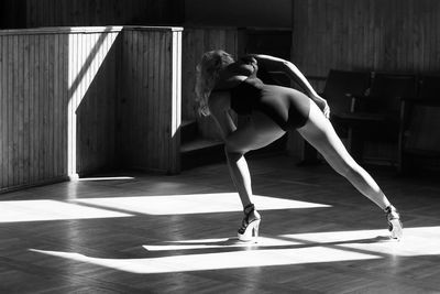 Full length of woman practicing dance in studio