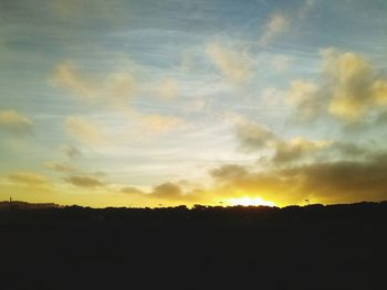 Silhouette landscape against sky during sunset