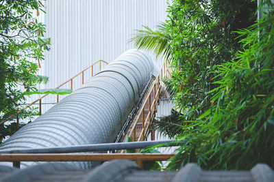 Low angle view of pipe against trees