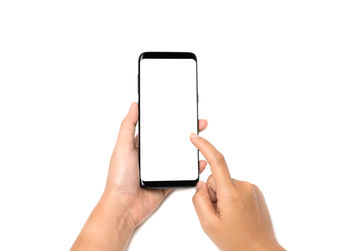 Midsection of man using mobile phone against white background