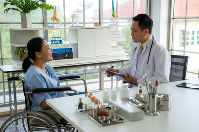 Side view of business colleagues working in office