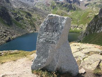 Tilt image of text on rock at shore