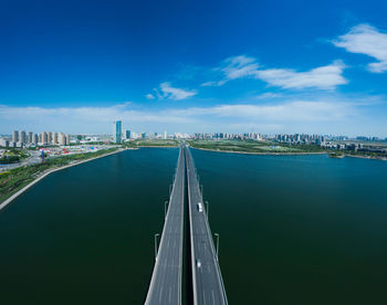Panoramic view of bridge and cityscape against sky