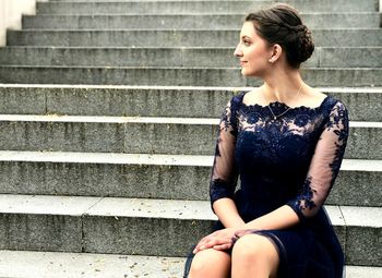 Young woman sitting on staircase