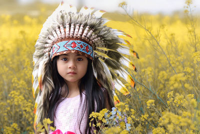 Portrait of girl amidst yellow flowers