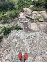 Low section of person standing on rock