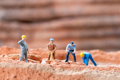 Men and figurine on land