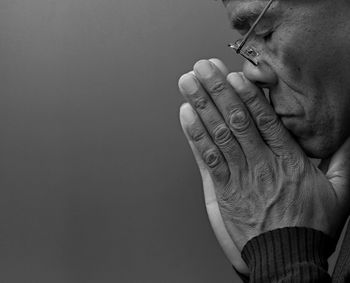 Cropped hand of woman against wall