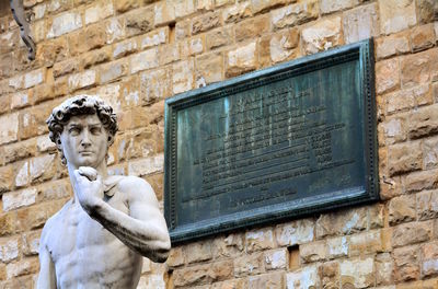 Low angle view of statue against wall