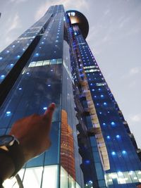 Low angle view of illuminated modern building against sky in city