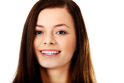 Portrait of a smiling young woman over white background