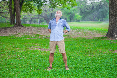 Full length of a man standing on grassland