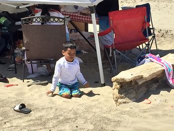 Full length of man sitting on beach