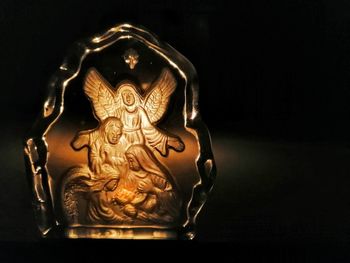 Close-up of statue against black background