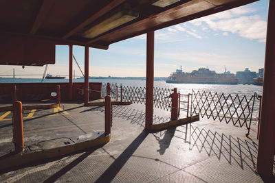 Ferry in river seen from harbor on sunny day
