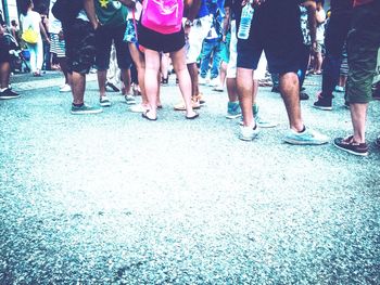 Low section of people standing on tiled floor
