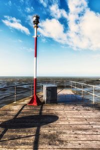 Lifeguard hut on beach against sky