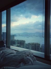 View of cityscape against cloudy sky