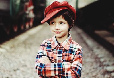 Portrait of boy wearing hat standing outdoors