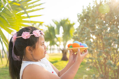 Portrait of girl holding plant