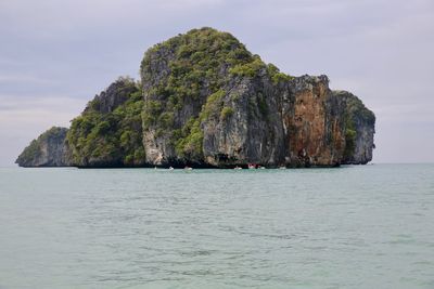 Scenic view of rock formation in sea against sky