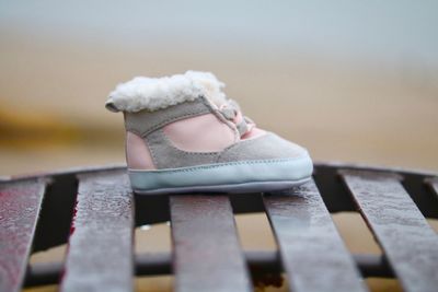 Close-up of baby booties on metal