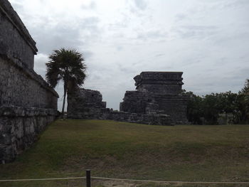 Ruins of temple against cloudy sky